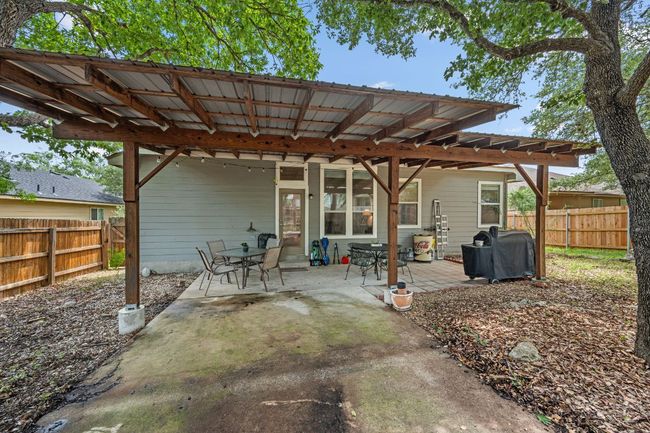 Fenced backyard with area for grilling, a patio, and outdoor dining space | Image 30