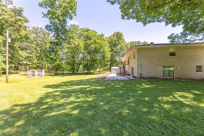 View of green lawn featuring a patio area | Image 25