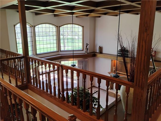 Staircase featuring coffered ceiling and beam ceiling | Image 63