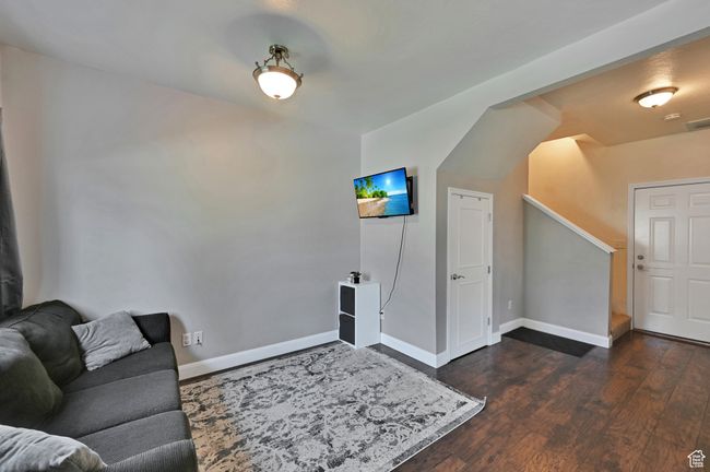 Living room with dark wood-type flooring | Image 10