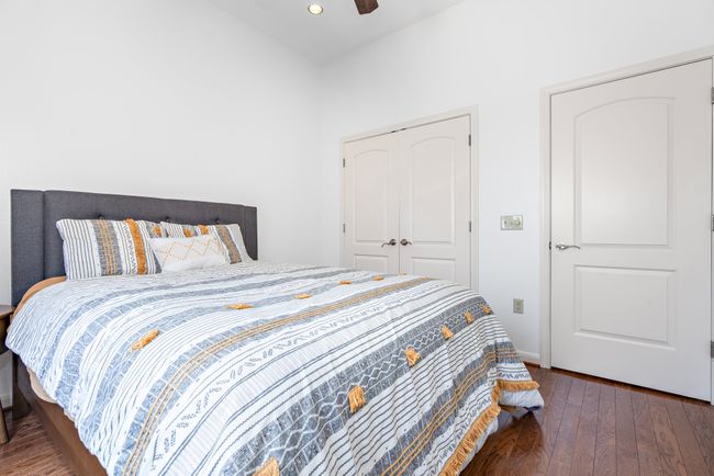 Bedroom with hardwood / wood-style floors, recessed lighting, baseboards, ceiling fan, and a closet | Image 10