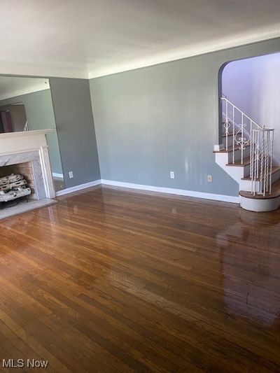 Unfurnished living room featuring dark hardwood / wood-style floors | Image 3