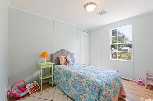 Bedroom featuring crown molding and wood finished floors | Image 25