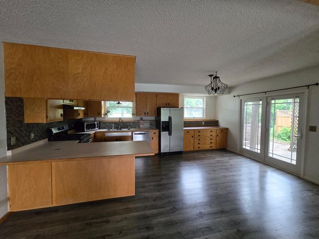 Breakfast bar and walkout to the patio | Image 5