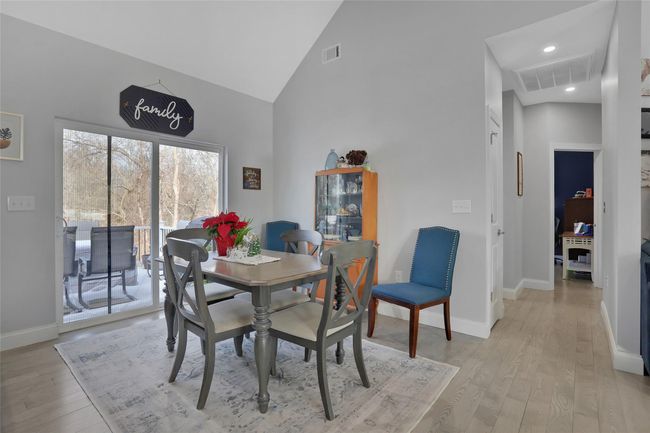 Dining room with light hardwood / wood-style floors and high vaulted ceiling | Image 11