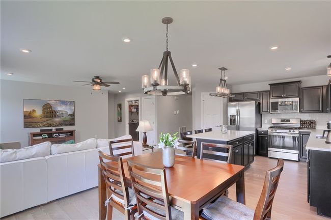 Dining area is spacious with sliding doors to a future deck overlooking green space. | Image 26