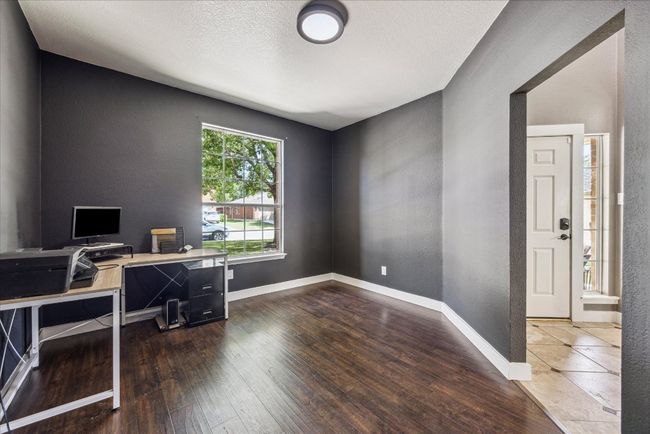 Office space with a textured wall, hardwood / wood-style flooring, and baseboards | Image 6