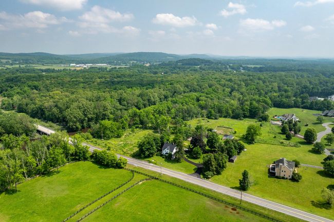 Aerial view of sparsely populated area with a forest | Image 43