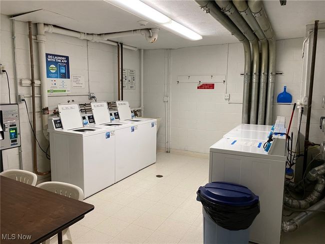 Community laundry room featuring independent washer and dryer and light floors | Image 18