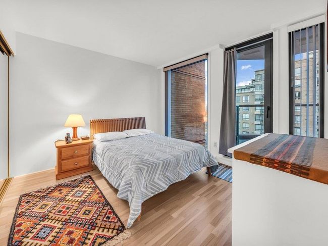 Bedroom featuring expansive windows, wood finished floors, and access to exterior | Image 10