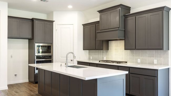 Kitchen with a sink, appliances with stainless steel finishes, decorative backsplash, dark wood-type flooring, and recessed lighting | Image 6