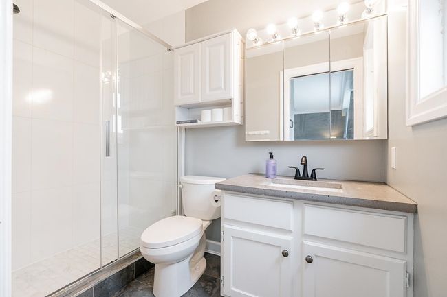 Bathroom with vanity, toilet, and a shower stall | Image 19