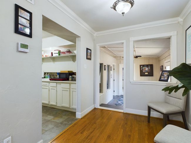 Corridor with crown molding and light wood finished floors | Image 10