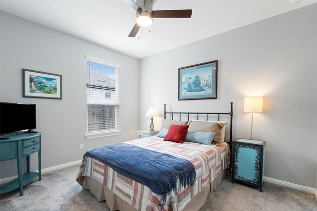 Secondary bedroom featuring carpet flooring, baseboards, and a ceiling fan. | Image 29