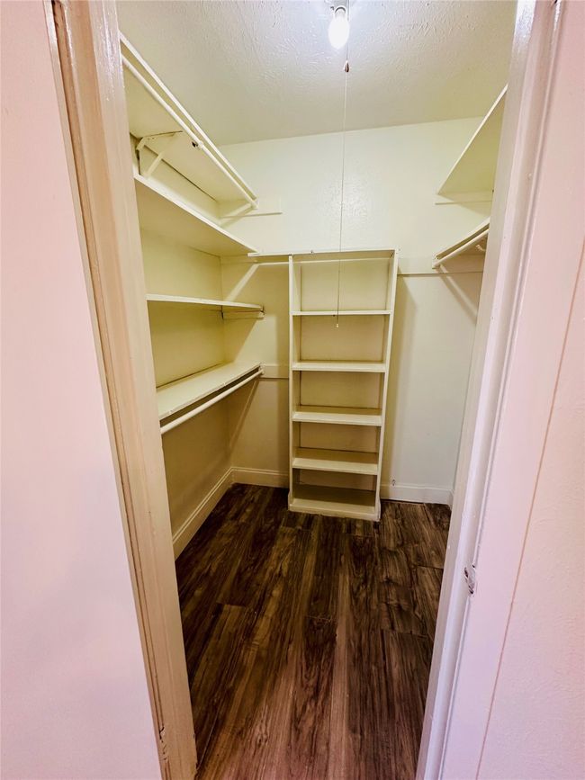 Walk in closet with dark wood-style floors | Image 12