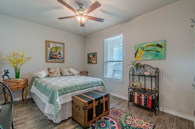 Bedroom featuring wood finished floors and a ceiling fan | Image 20