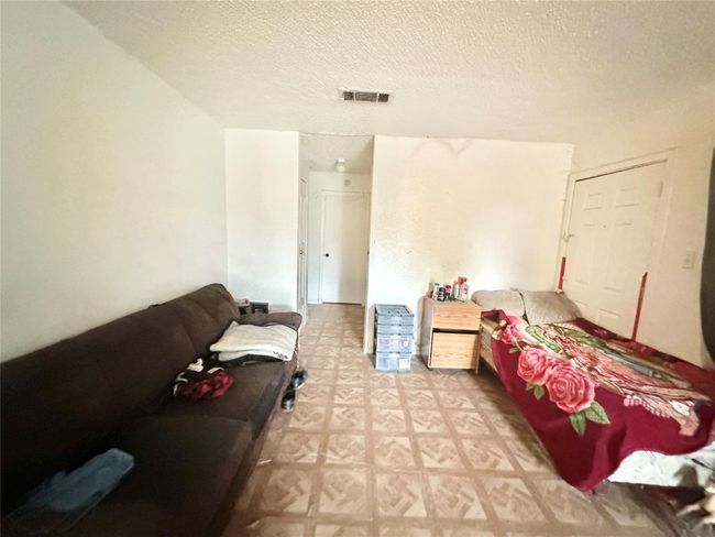 Bedroom with a textured ceiling | Image 10