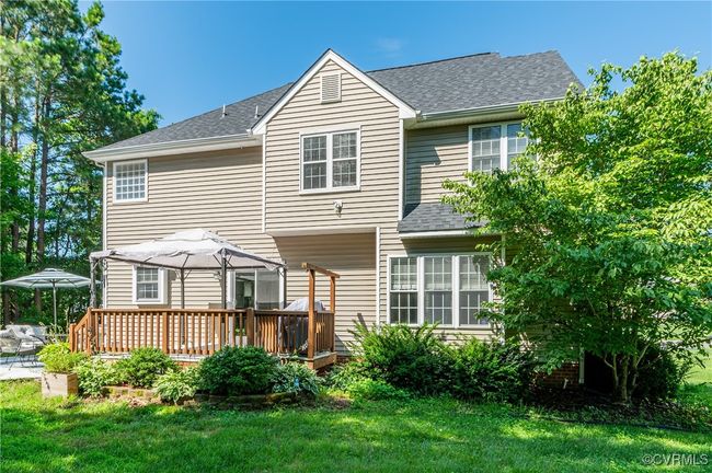 Back of house featuring a shingled roof, a yard, and decks | Image 41