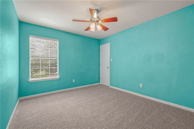 Carpeted empty room with a ceiling fan and baseboards | Image 17