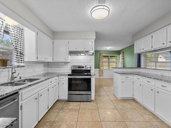 Kitchen overlooks the living area and Breakfast nook off to the side. | Image 8