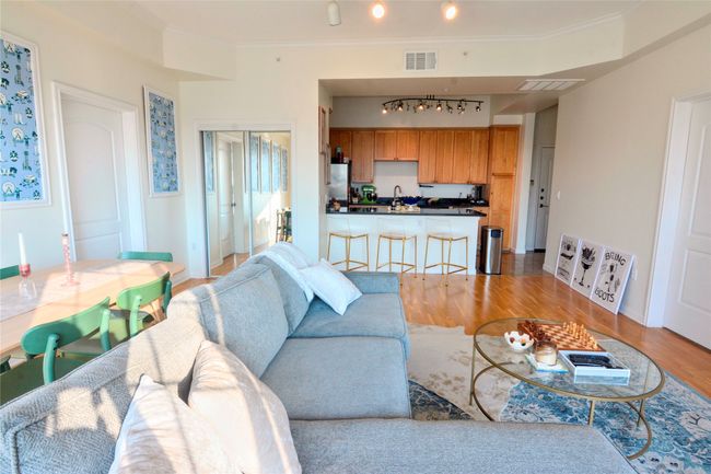 Living room with light wood finished floors and ornamental molding | Image 34