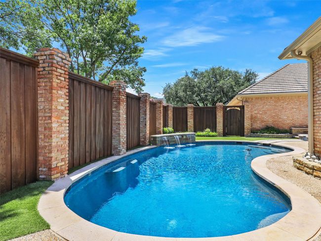View of pool with a fenced backyard | Image 34