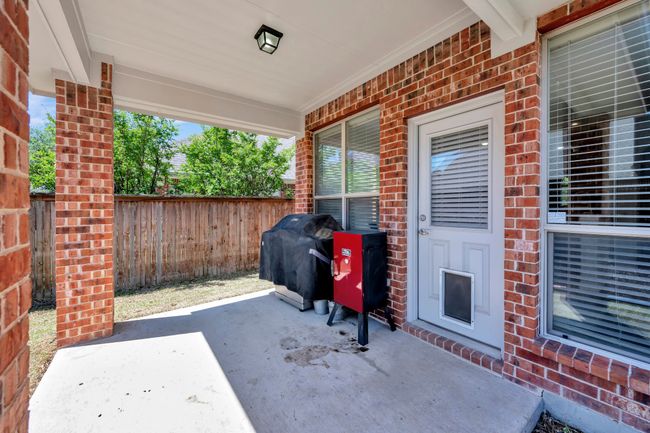 Outside, enjoy shade under the covered patio or roam in this yard | Image 40