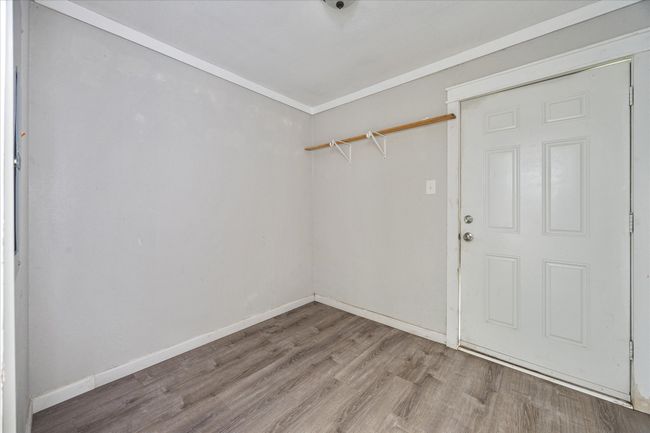 Spare room featuring wood finished floors and baseboards | Image 19