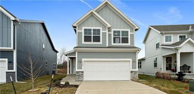 View of front of property featuring a garage and a front lawn | Image 1