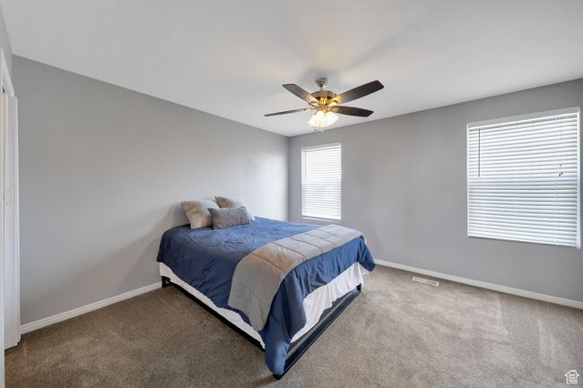 Primary bedroom with ceiling fan | Image 8