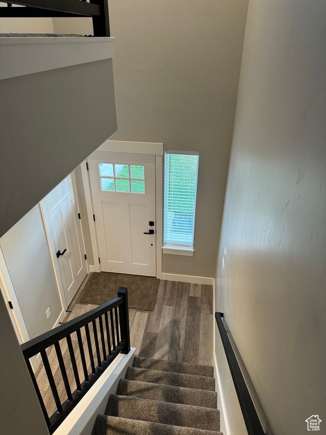 Stairs with wood-type flooring and a high ceiling | Image 7