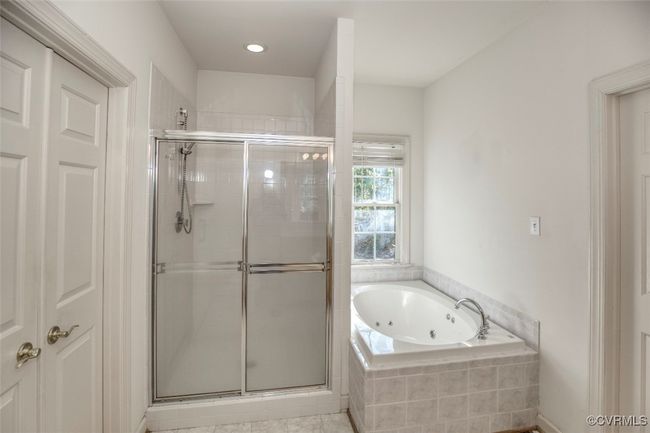 Full bath featuring a tub with jets and a stall shower | Image 22
