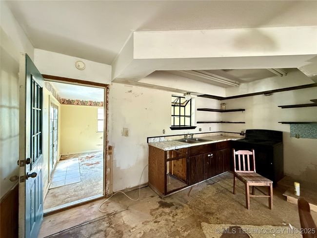 KITCHEN HAS A DOOR LEADING TO A BONUS ROOM THAT LOOKS LIKE IT WAS ONCE A PATIO | Image 8