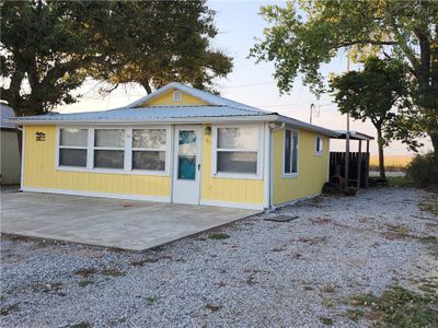 Back house at dusk featuring a patio | Image 1