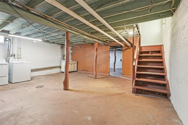 Unfinished below grade area with stairway and washer and clothes dryer | Image 33