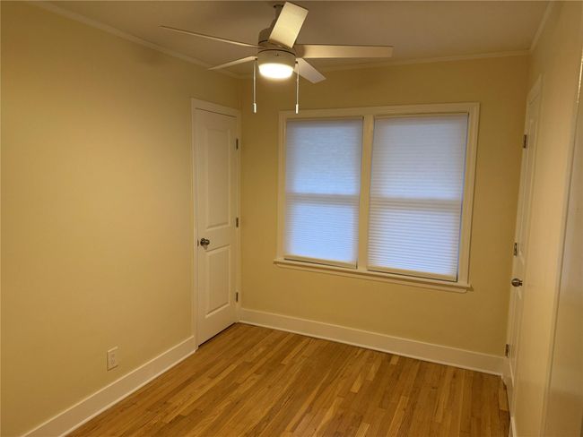 Unfurnished room with light wood finished floors, a ceiling fan, and ornamental molding | Image 21