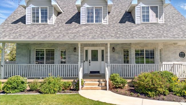 New england style home with covered porch and a shingled roof | Image 33