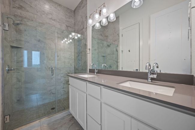 Gorgeous Master bathroom with double vanity, a shower stall, and marble finish flooring | Image 15