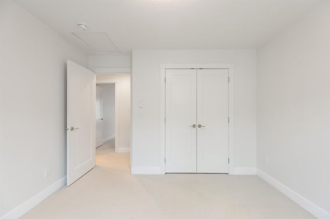 Unfurnished bedroom featuring light carpet, baseboards, and a closet | Image 21