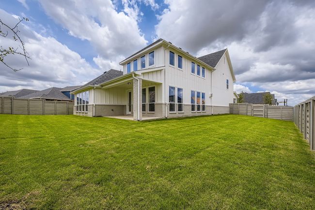 Back of property featuring board and batten siding, a fenced backyard, a patio, brick siding, and roof with shingles | Image 29