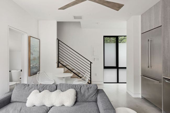 Living area with finished concrete flooring, stairs, and a ceiling fan | Image 34