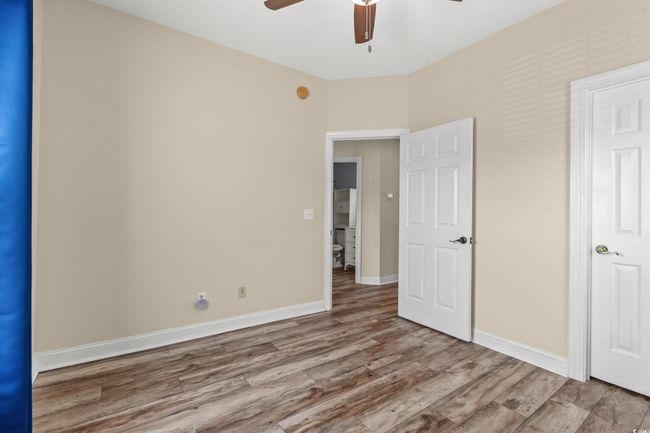 Unfurnished bedroom featuring baseboards, ceiling fan, and wood finished floors | Image 17