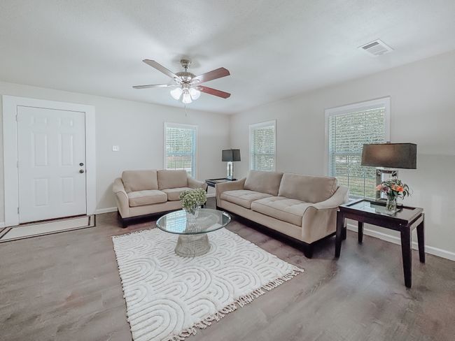 Living area featuring wood finished floors and a ceiling fan | Image 4