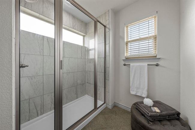 Full bathroom featuring a shower stall, baseboards, and plenty of natural light | Image 14