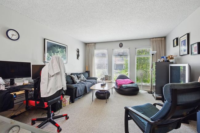 Office area with a textured ceiling and carpet floors | Image 10