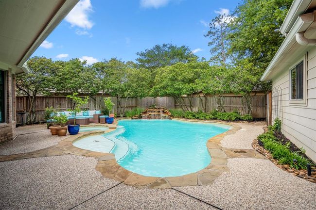 Step outside and enjoy the outdoors, an expansive patio area with spa and rock waterfall are all you need to relax over the weekend. | Image 36