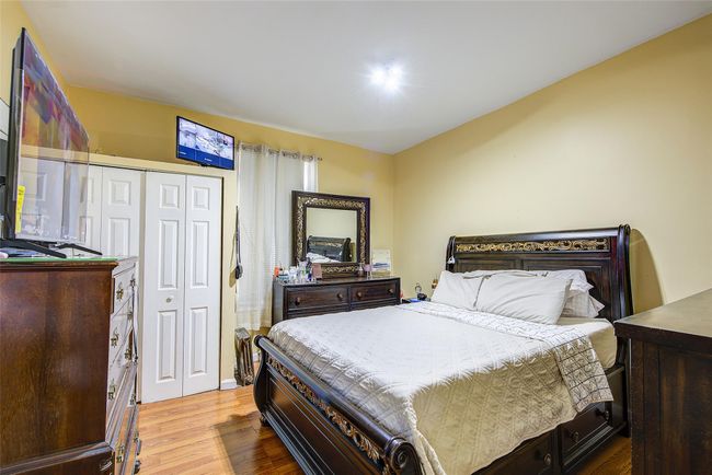 Bedroom featuring wood finished floors and a closet | Image 27