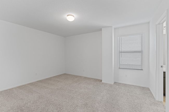 Spare room featuring baseboards and light colored carpet | Image 24