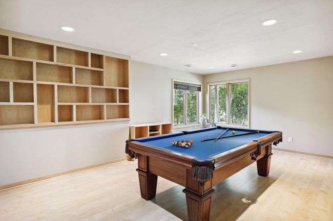 Game on in this fabulous lower level amusement, game room area! Ready for entertaining all! Hardwood floors throughout home is a wonderful upgrade. | Image 37