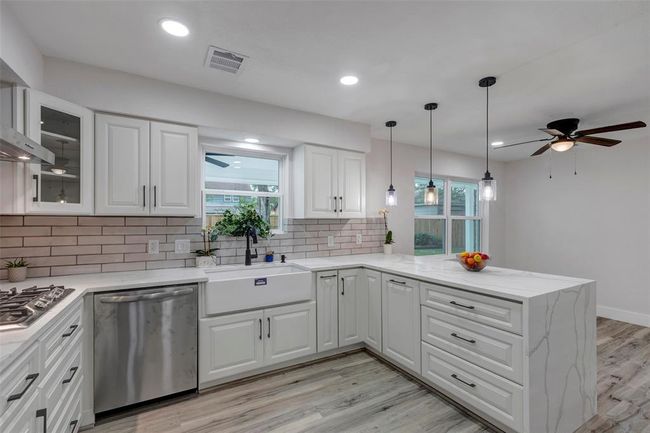 Completely newly remodeled kitchen with new appliances, Quartz countertops, light fixtures, cabinets and Vinyl flooring! | Image 18